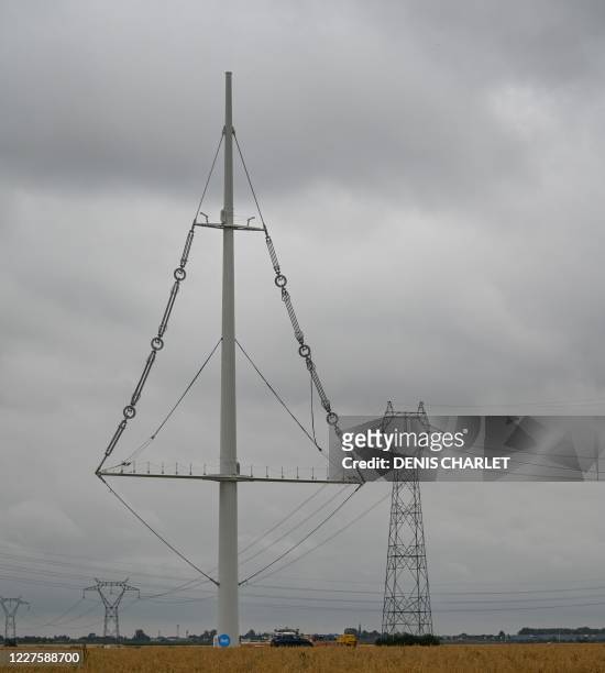 An imgae of the new electricity pylon installed by RTE near the town of Flers in Escrebieux, northern France on July 16, 2020. - A central mast and a...