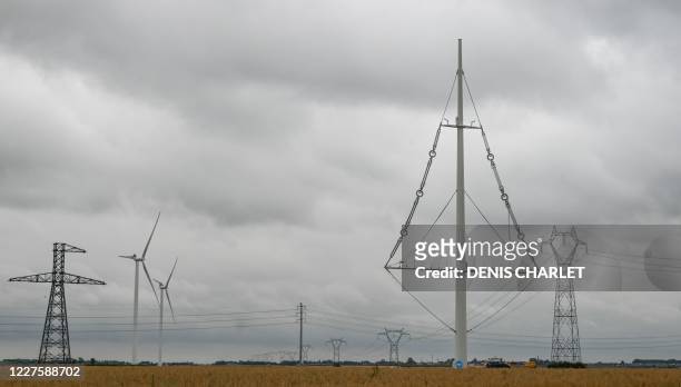An imgae of the new electricity pylon installed by RTE near the town of Flers in Escrebieux, northern France on July 16, 2020. - A central mast and a...