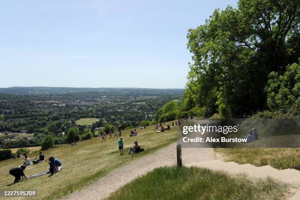 General view as members of the public relax on the grass at Box Hill on May 28, 2020 in Tadworth, England. The British government continues to ease...