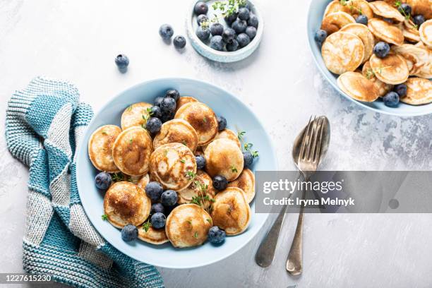 small pancakes or poffertjes, dutch cuisine - warm colors stock pictures, royalty-free photos & images