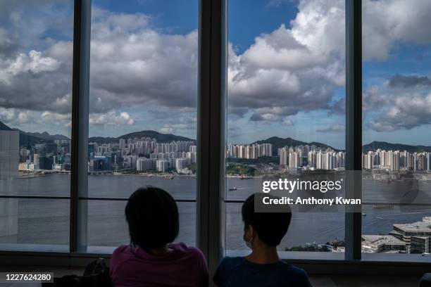 Couple of women sit in front of a skyline on July 16, 2020 in Hong Kong, China. U.S President Donald Trump ordered to end Hong Kongs special status...
