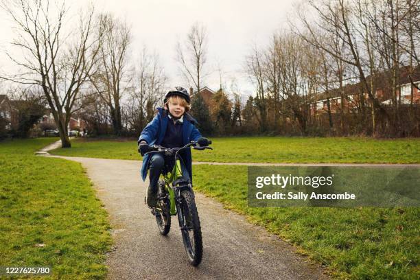child on a bike in the park - cycling uk stock pictures, royalty-free photos & images