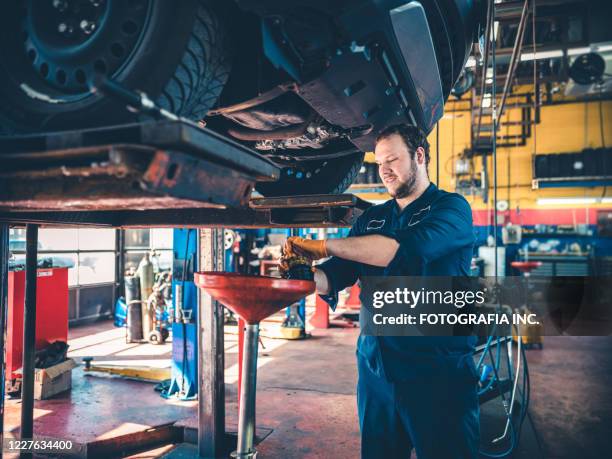 auto mechanic working on car - oil change stock pictures, royalty-free photos & images