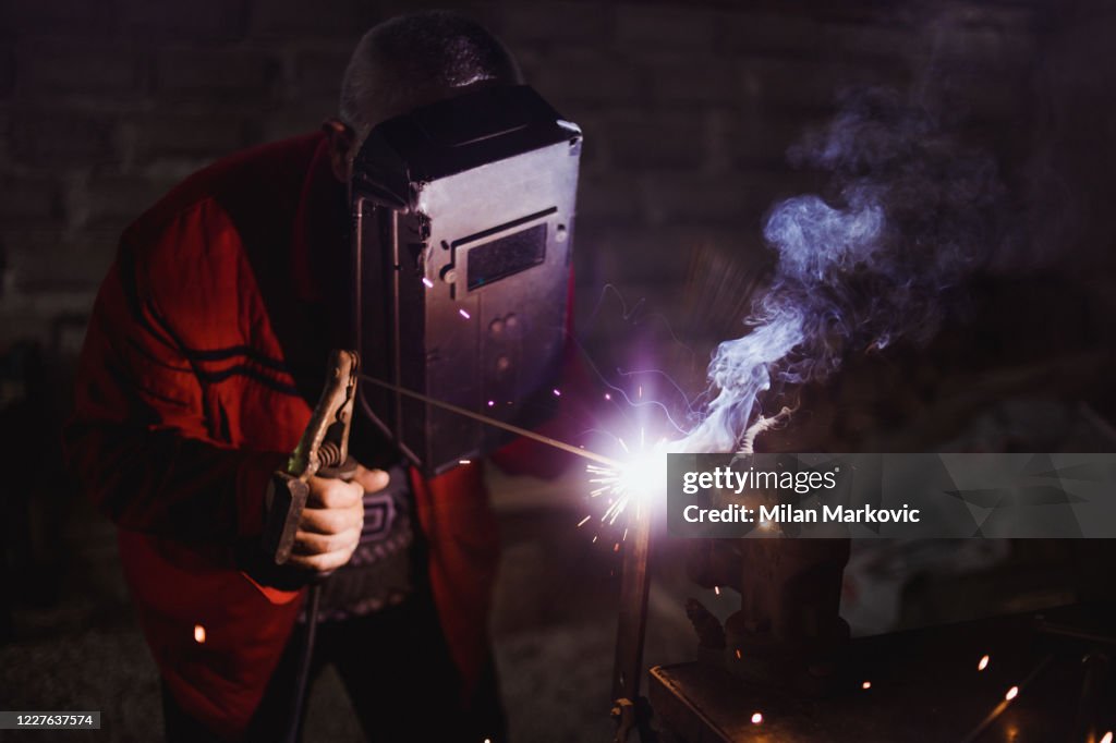 The welder works in his workshop