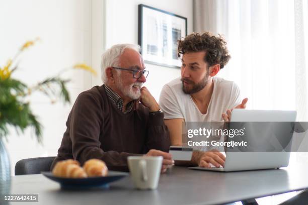 online shopping - grandpa son stock pictures, royalty-free photos & images