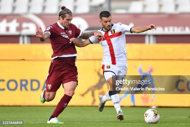 Vojnovic Lyanco of Torino FC competes with Iago Falque of Genoa CFC during the Serie A match between Torino FC and Genoa CFC at Stadio Olimpico di...