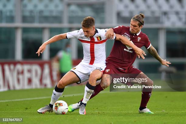 Vojnovic Lyanco of Torino FC competes with Andrea Pinamonti of Genoa CFC during the Serie A match between Torino FC and Genoa CFC at Stadio Olimpico...