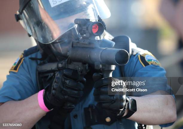 Police officer aims a tear gas gun at protesters on May 28, 2020 in St. Paul, Minnesota. Today marks the third day of ongoing protests after the...