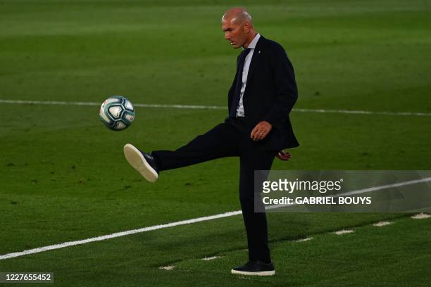 Real Madrid's French coach Zinedine Zidane kicks the ball during the Spanish League football match between Real Madrid CF and Villarreal CF at the...