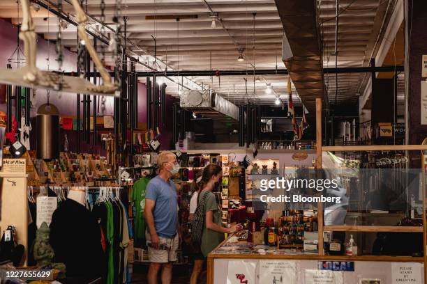 Customers wear a protective mask while shopping at a store in downtown Asheville, North Carolina, U.S., on Wednesday, July 15 2020. At least 93,426...