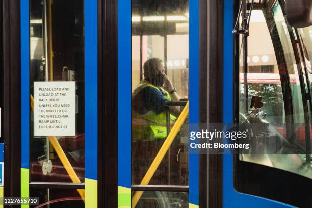 Driver wears a protective mask while riding a bus in downtown Asheville, North Carolina, U.S., on Wednesday, July 15 2020. At least 93,426 people in...
