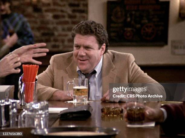 George Wendt as Norm Peterson in the "Cheers" episode 'The Improbable Dream: Part 2,' which originally aired on September 28, 1989. Image is a screen...