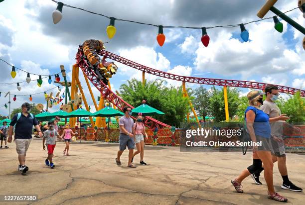 Guests walk past the the Slinky Dog Dash roller coaster on the second day of the re-opening of Disney's Hollywood Studios at Walt Disney World, in...