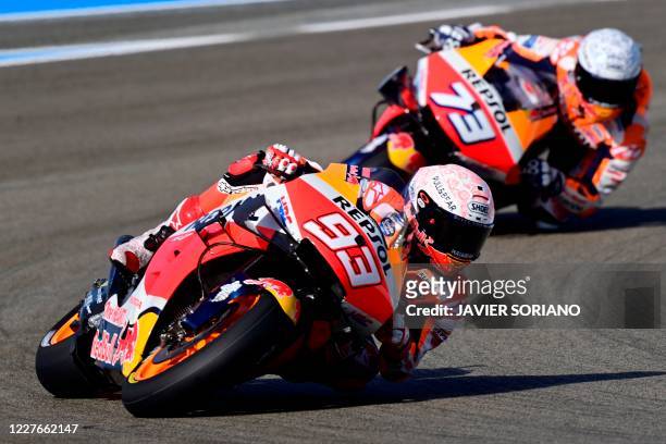 Repsol Honda Team's Spanish rider Marc Marquez rides ahead of his brother, Repsol Honda Team's Spanish rider Alex Marquez, during the first MotoGP...