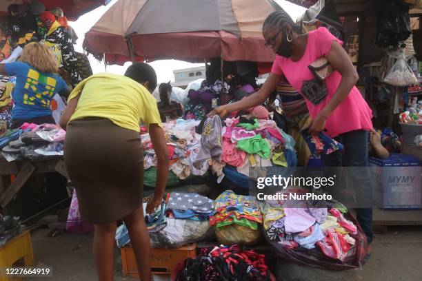 Traders sell where overhead bridge construction is ongoing in Agege, Lagos, Nigeria on Friday, July 3, 2020. Economic activities are bouncing back...