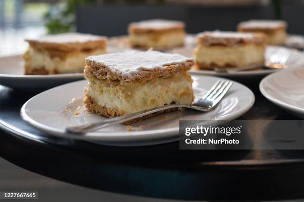 Set of traditional 'Kremowka' - a Polish type of cream pie, ready to be served to clients inside a coffee shop in ArtSfera NMK. The National Museum...