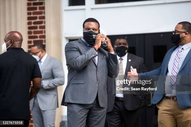 Attorney Lee Merritt, representing the family of Ahmaud Arbery, talks on the phone outside the Glynn County Courthouse on July 17, 2020 in Brunswick,...