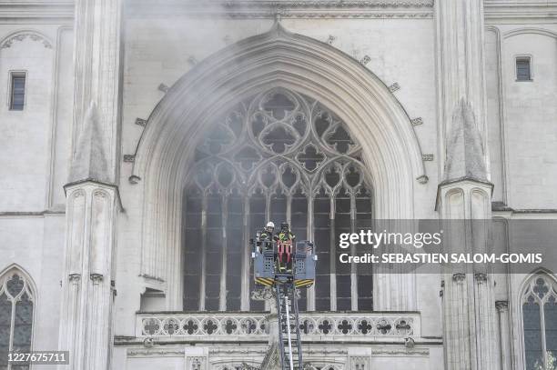 Firefighters are at work to put out a fire at the Saint-Pierre-et-Saint-Paul cathedral in Nantes, western France, on July 18, 2020. The major fire...