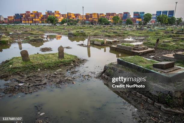 View of public cemetery which submerged by flood waters from rising sea levels on July 18, 2020 in North Jakarta, Indonesia. Since the 1970s, parts...