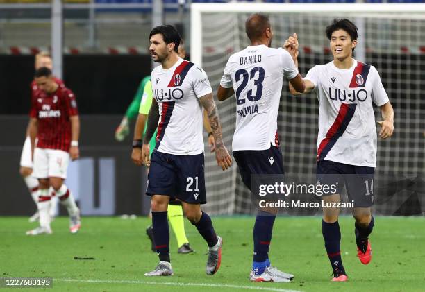 Takehiro Tomiyasu of Bologna FC celebrates his goal with his team-mate Danilo Larangeira during the Serie A match between AC Milan and Bologna FC at...