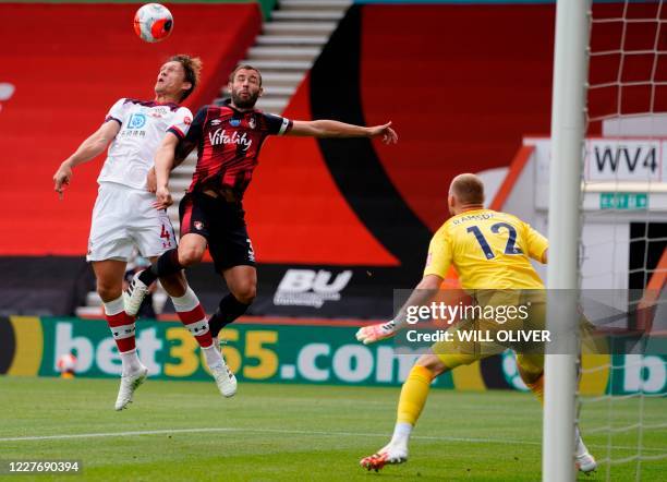 Southampton's Danish defender Jannik Vestergaard jumps for the ball with Bournemouth's English defender Steve Cook during the English Premier League...