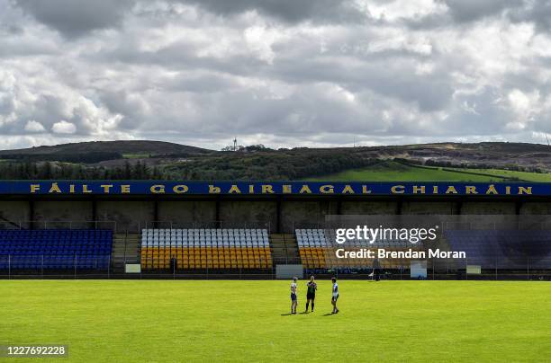 Tyrone , United Kingdom - 19 July 2020; Referee Mark O'Neill performs the coin toss in the company of captains Mark Kavanagh of Errigan Ciaran, left,...