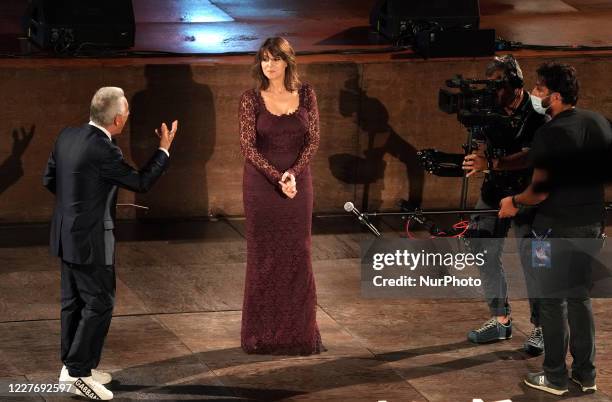 Monica Bellucci attend the ceremony in memory of Ennio Morricone in the suggestive ancient theater of Taormina with the presentation of the film by...