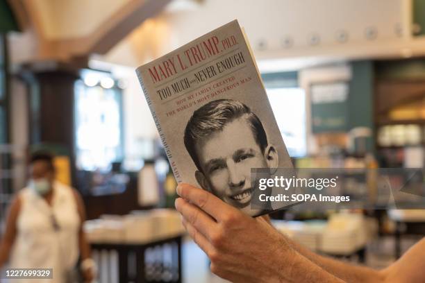 Customer looks through Mary L. Trump's new book about the U.S. President Donald J. Trump is on display at Barnes & Noble store on Broadway in...