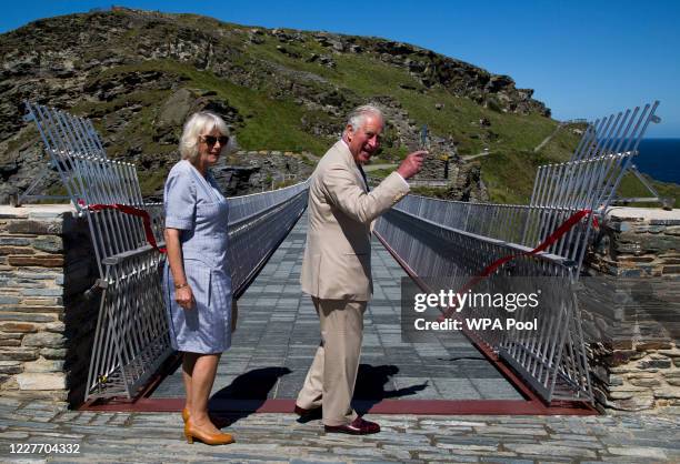 Prince Charles, Prince of Wales and Camilla, Duchess of Cornwall smile after a ribbon cutting ceremony at the new Tintagel bridge during their visit...