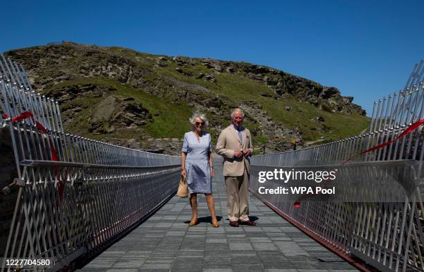 Prince Charles, Prince of Wales and Camilla, Duchess of Cornwall pose after a ribbon cutting ceremony at the new Tintagel bridge during their visit...