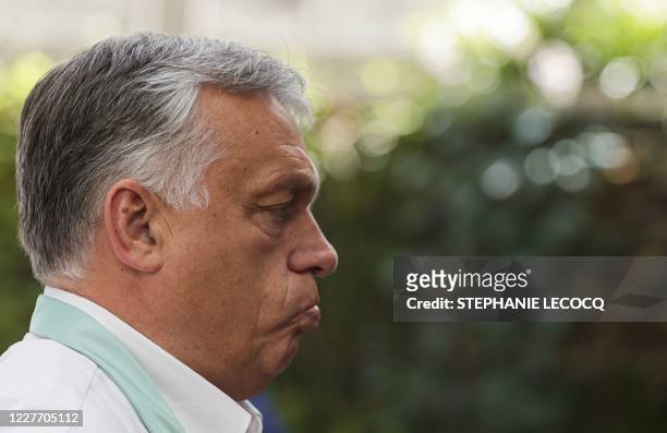 Hungary's Prime Minister Viktor Orban, reacts as he arrives for the fourth day of an EU summit at the European Council building in Brussels, on July...