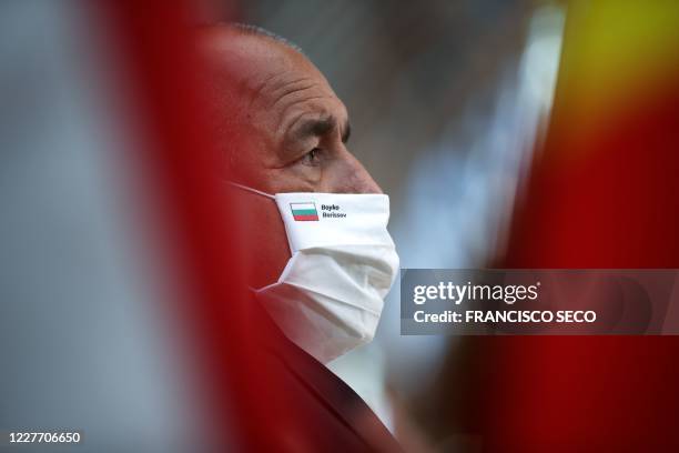 Bulgaria's Prime Minister Boyko Borissov, wears a protective face mask with his name on it, as he arrives for the fourth day of an EU summit at the...