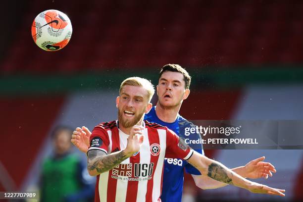 Sheffield United's English-born Scottish striker Oliver McBurnie vies for the ball with Everton's English defender Michael Keane during the English...