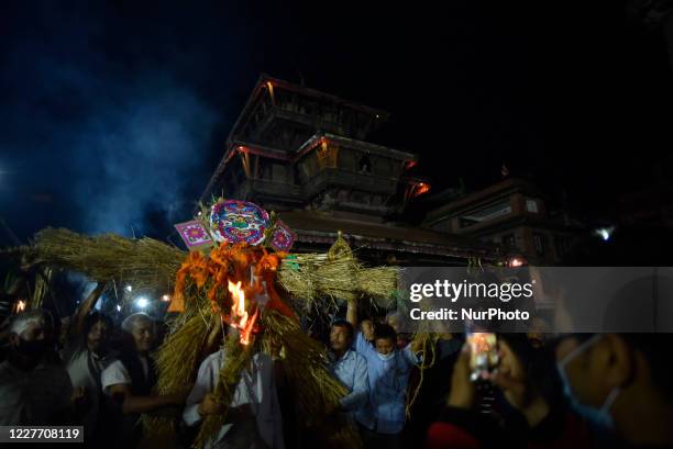 Nepalese devotee carrying straw effigy demon Ghantakarna during the Gathemangal festival celebrated at Bhaktapur, Nepal Sunday, July 19, 2020....