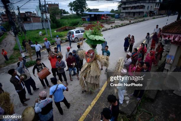 Nepalese devotee carrying straw effigy demon Ghantakarna during the Gathemangal festival celebrated at Bhaktapur, Nepal Sunday, July 19, 2020....