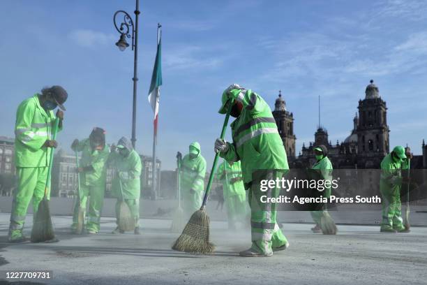 Group of workers sweep the square during maintenance work to replace the asphalt around the Plaza de la Constitucion at Zocalo on July 20, 2020 in...