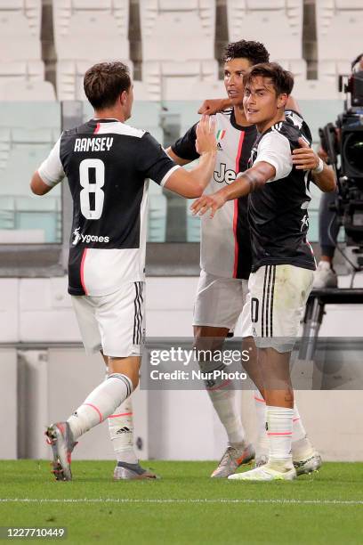 Cristiano Ronaldo of Juventus celebrates with Paulo Dybala of Juventus and Aaron Ramsey of Juventus after scoring the his second goal during the...