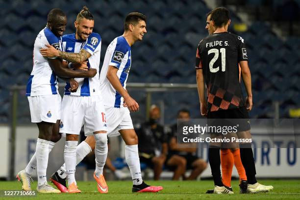 Moussa Marega of FC Porto celebrates with Alex Telles after scores a goal during the Liga Nos match between FC Porto and Moreirense FC at Estadio do...