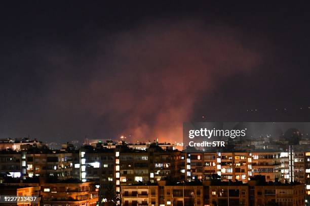 Smoke billows following an Israeli airstrike targeting south of the capital Damascus, on July 20, 2020. - Israeli strikes south of the Syrian capital...