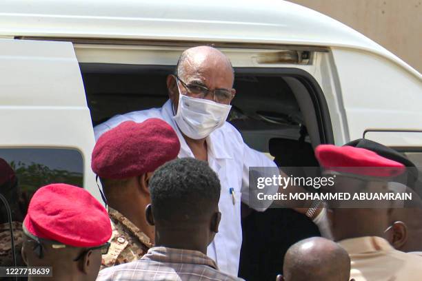 This AFPTV screen grab from footage aired July 21, 2020 shows Sudan's ousted President Omar al-Bashir disembarking from a vehicle upon arriving at...