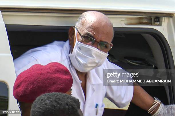 This AFPTV screen grab from footage aired July 21, 2020 shows Sudan's ousted President Omar al-Bashir disembarking from a vehicle upon arriving at...