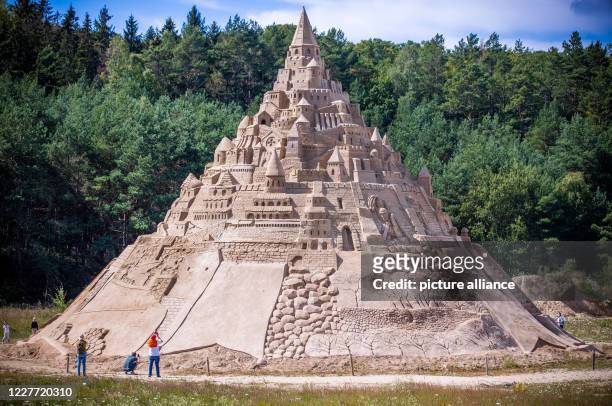 July 2020, Mecklenburg-Western Pomerania, Binz: The highest sand castle in the world stands at the Sand Sculpture Festival on the Baltic Sea island...