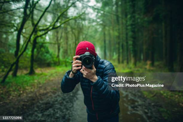 Portrait of a man taking pictures on a woodland track with a Canon EOS-1 digital SLR camera, taken on April 9, 2019.