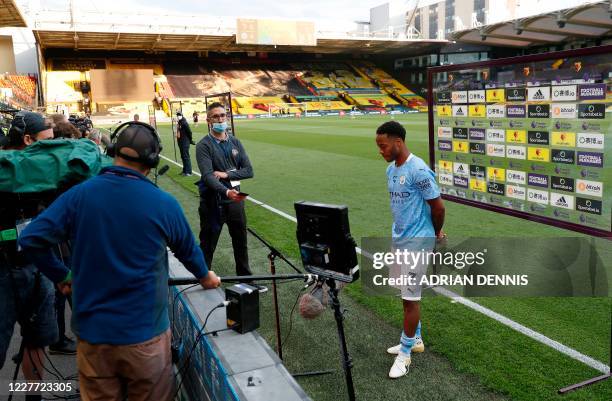 Manchester City's English midfielder Raheem Sterling reacts during the post-match interview after the English Premier League football match between...