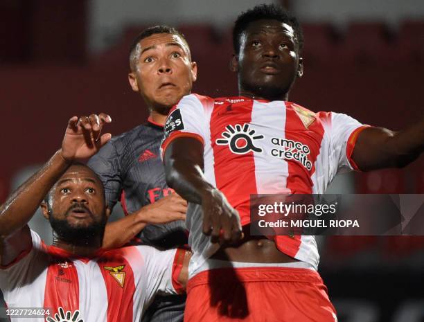 Benfica's Brazilian forward Carlos Vinicius jumps for a ball with Aves' Senegalese defender Diakhite and Chadian forward Marius during the Portuguese...