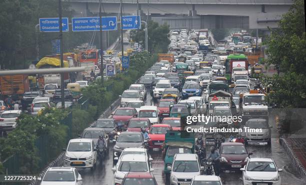 Commuters stuck in heavy traffic congestion due to rains and waterlogging, at Akshardham Temple Road, on July 21, 2020 in New Delhi, India. Heavy...