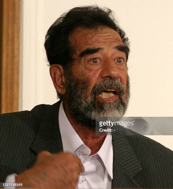 Former Iraqi president Saddam Hussein talk to an Iraqi judge during his initial interview at an undisclosed location in Baghdad 01 July 2004, to be...
