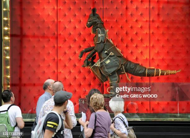 Shoppers walk past a retail store window display in central Sydney on November 29, 2011. Australia on November 29 announced billions of dollars in...