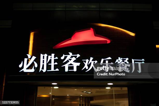 An illuminated sign from the Pizza Hut fast food franchise on a street. On 2 March 2012, in Shenzhen, China.
