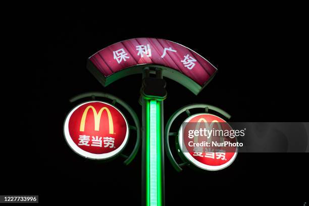 An illuminated sign from the Mc Donald's fast food franchise on a street. On 2 March 2012, in Guangzhou, China.